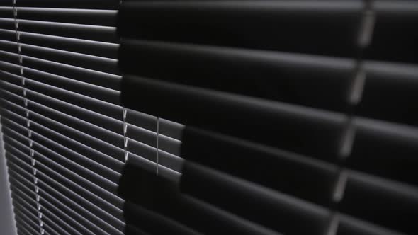 Blinds on a Window in a Dark Room Against the Light alt