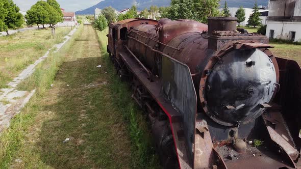 Old Train Cemetery. Aerial View of an Old Abandoned Rusty Steam Train. alt