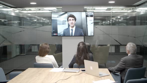 Employees Listening To Young Leader During Video Conference alt
