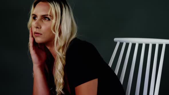 Androgynous man posing against black background alt