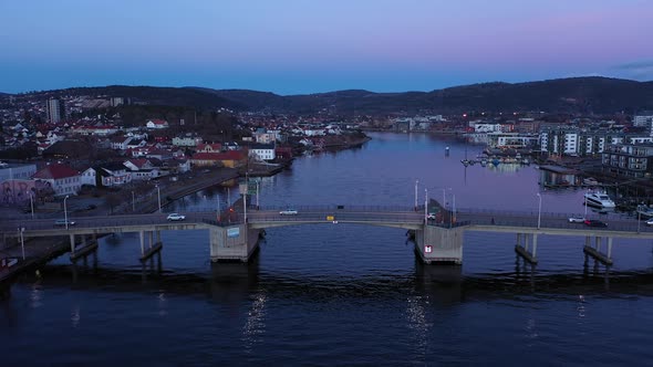 Porsgrunn city bridge - Late evening aerial showing traffic passing ove channel bridge at dawn - Cal alt
