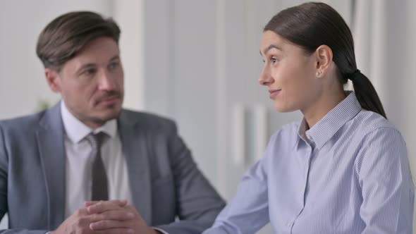 Young Businesswoman Talking to Attractive Middle Aged Businessman alt