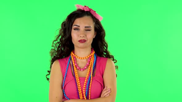 Girl Standing Arms Crossed, Nervous. Eye Spasm Concept. Green Screen at Studio alt