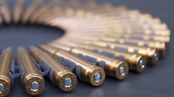 Sniper or machine gun ammo belts on a production line. Deadly ammunition. alt