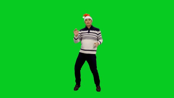 Happy Man in Santa Hat Performing Stylish Dance at Christmas Party