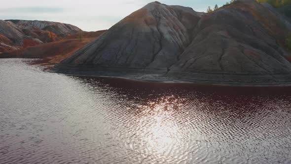 Aerial View of a Landscape Similar To the Planet Mars with Red Hills and Rivers with Red Water alt