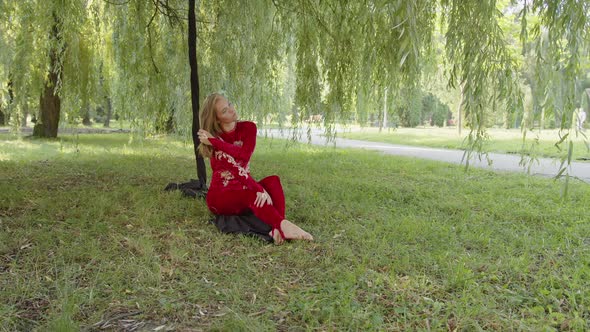 Girl Sits Beside Her Aerial Silk in the Park alt