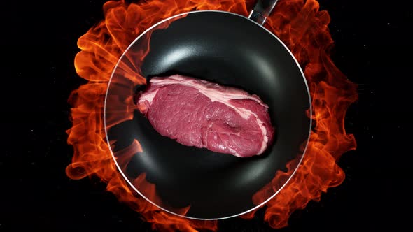 Super Slow Motion Shot of Throwing Beef Meat on Frying Pan and Fire Blast at 1000Fps alt
