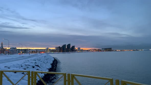 Wide shot of Reykjavik City and Atlantic Ocean in winter after sunset time on Iceland alt