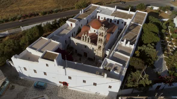 Aerial view of Agios Nikolaos church in Spetses next to a road, Greece. alt