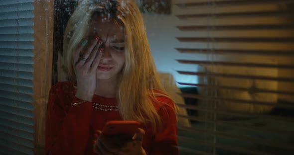 Woman Reading Her Smartphone and Crying alt