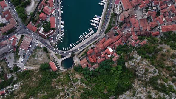 Cinematic birdseye aerial over the old town and the harbour in Kotor Montenegro a popular destinatio alt