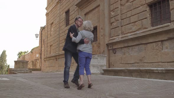 Senior couple dancing outdoors