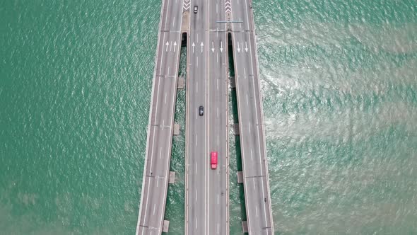 Aerial surface view of Penang Bridge Malaysia traffic lanes with bidirectional traffic, drone bird's alt