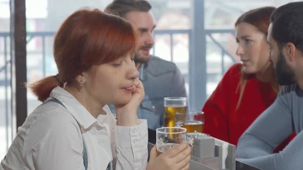 Sad Woman Drinking Beer at the Pub
