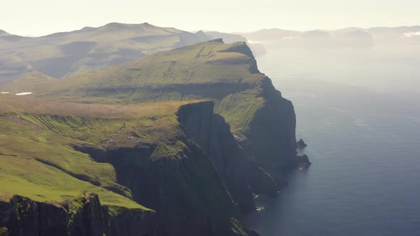 Drone Shot Of Men Hiking By Mylingur Mountain On Streymoy Island alt
