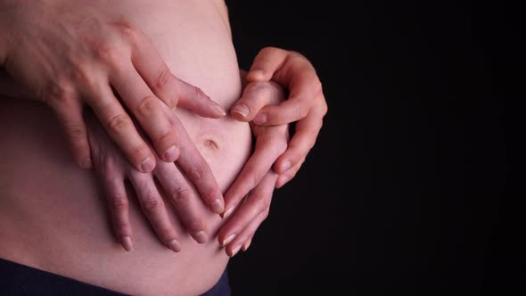 Couple Hands on Pregnant Belly  alt