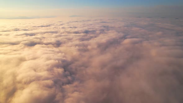 4K Aerial video Beautiful sunrise above dense clouds and fog in the morning alt