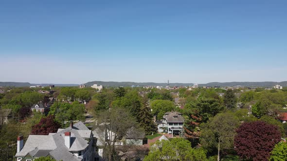 Residential neighborhoods with mountains in the distance and a blue sky.