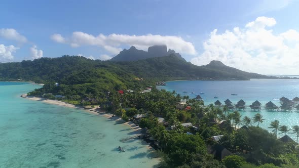 Aerial drone view of a luxury resort and overwater bungalows in Bora Bora tropical island alt