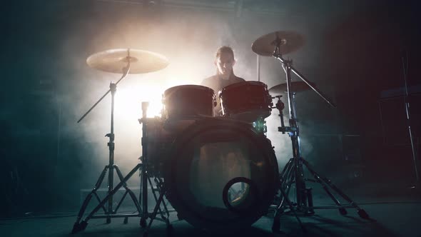 Dark Studio with a Man Rehearsing Drumming in It. Drum Set, Drum Kit in Dark, Drummer Plays a alt