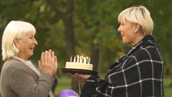 Adult Daughter Wishes Old Mother Happy Birthday, Giving Cake, Family Celebration alt