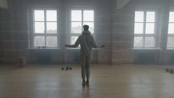 Man Jumping Rope In Smoky Loft alt
