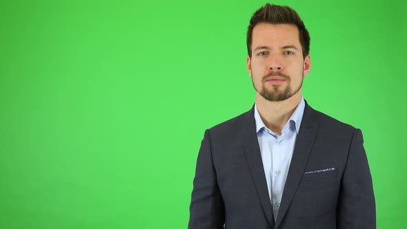 A Young Handsome Businessman Talks Seriously To the Camera - Green Screen Studio alt