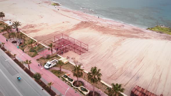 Crushed and cleaned sand on beach for placement of wooden walkways, preparing for summer tourism sea alt