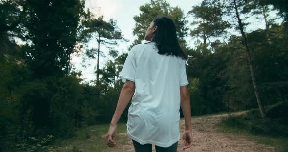 Young Adult Woman From Back Walk in Forest on Summertime Hike Journey alt