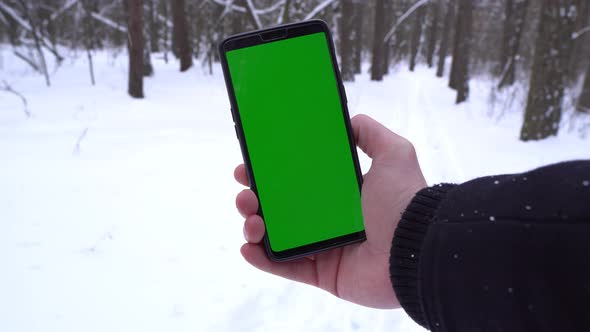 Man Holding A Mobile Phone In The Forest, Man Got Lost, Snowy Forest, Navigator