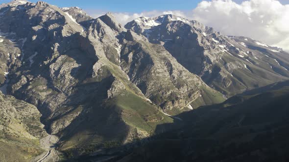 Snowy peaks among mountains in spring