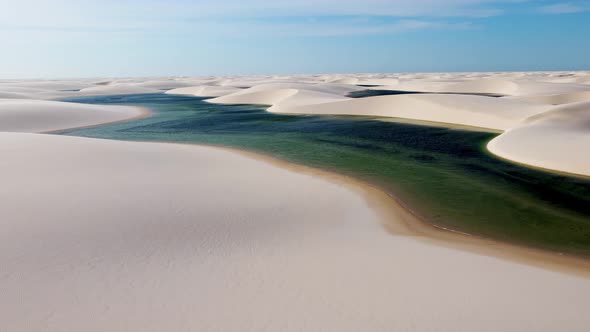 Paradisiac waves scenery of rainwater lakes and sand dunes at Brazil. alt
