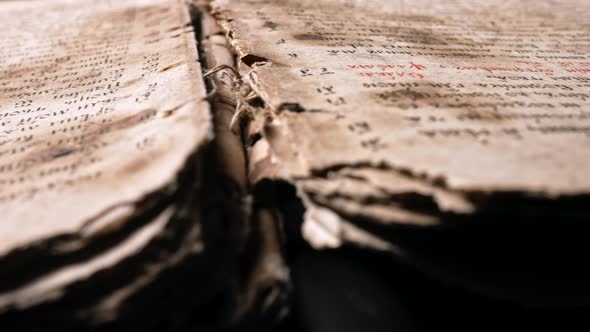 Slider Shot Over Pages with Candle Wax Stains of Old Antique Religious Book alt