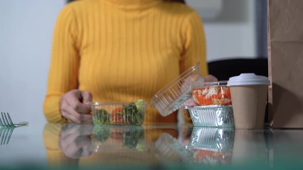 Woman Eating Vegetables From a Plastic Box Vegan Salad in a Container From a Delivery Service alt