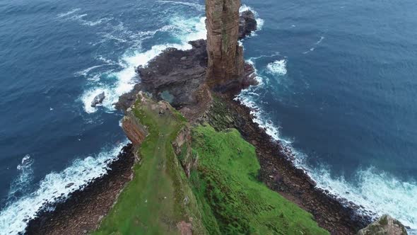Slow motion, reveal shot of the Old Man oh Hoy, a 449ft high sea stack on Hoy, Orkney, Scotland. alt