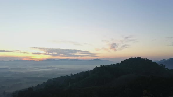 Aerial View Scenery Sunrise Mist Above The Mountain In Tropical Rainforest. alt