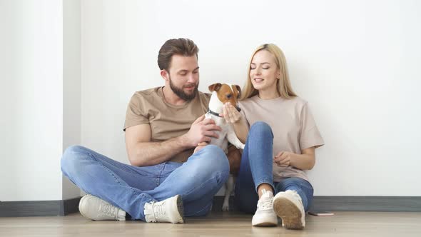 Young Couple With Dog At Home Having Fun Enjoy Spending Time Together