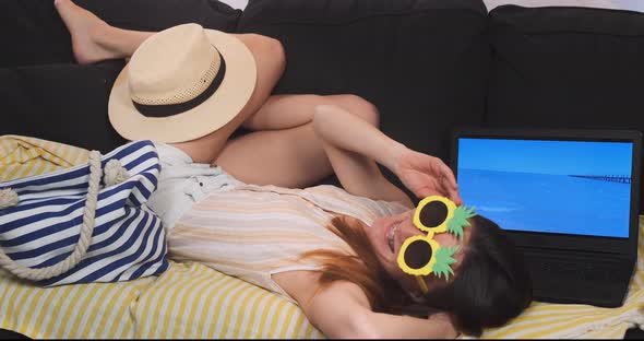 Funny Woman Imitates Sea Holiday on Home Couch alt