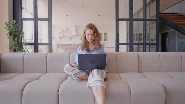 Lady Browsing Using Computer in Apartment