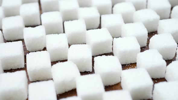 White Lump Sugar Refined on Brown Wooden Surface