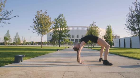 Sports Woman Makes Morning Jog and Physical Exercises In  Park alt