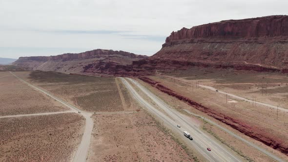 Interstate Highway Road by Tall Desert Cliffs in Southwest Utah Desert near Moab alt