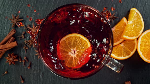 Super Slow Motion Shot of Orange Slice Falling and Splashing Into Mulled Wine at 1000 Fps alt