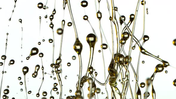 Super Slow Motion Shot of Splashing Oil Isolated on White Background at 1000Fps alt