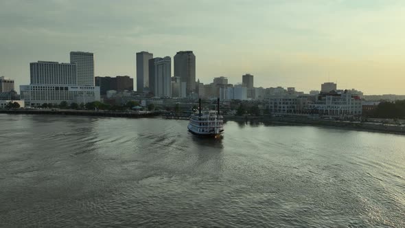 Aerial view of New Orleans and paddlewheel boat cruising alt