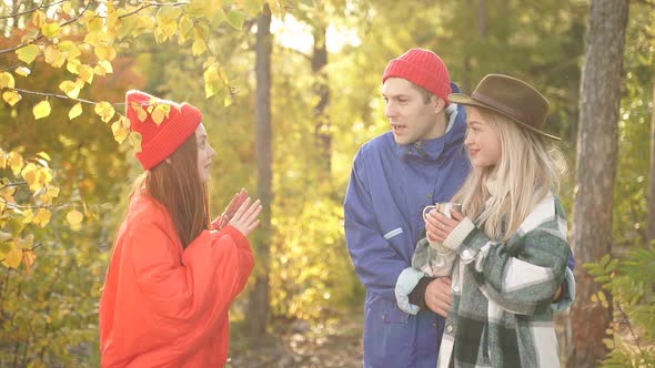Happy Group of Tourists Have Fun in the Autumn Forest Socialize and Enjoy the Rest