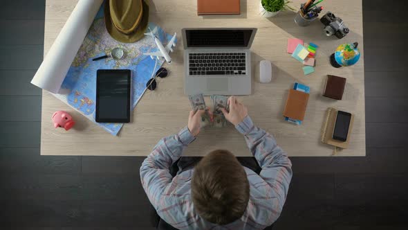 Man Counting Money, Rejoicing on Eve of Voyage Across Ocean, Preparing for Tour alt