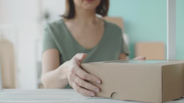 Saleswoman Preparing Order for Online Customer alt