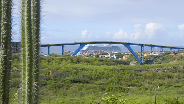 View looking over Willemstad and the Queen Juliana Bridge with a cruise ship in the background on th alt